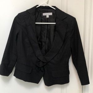 Black cropped jacket with frilled collar front.